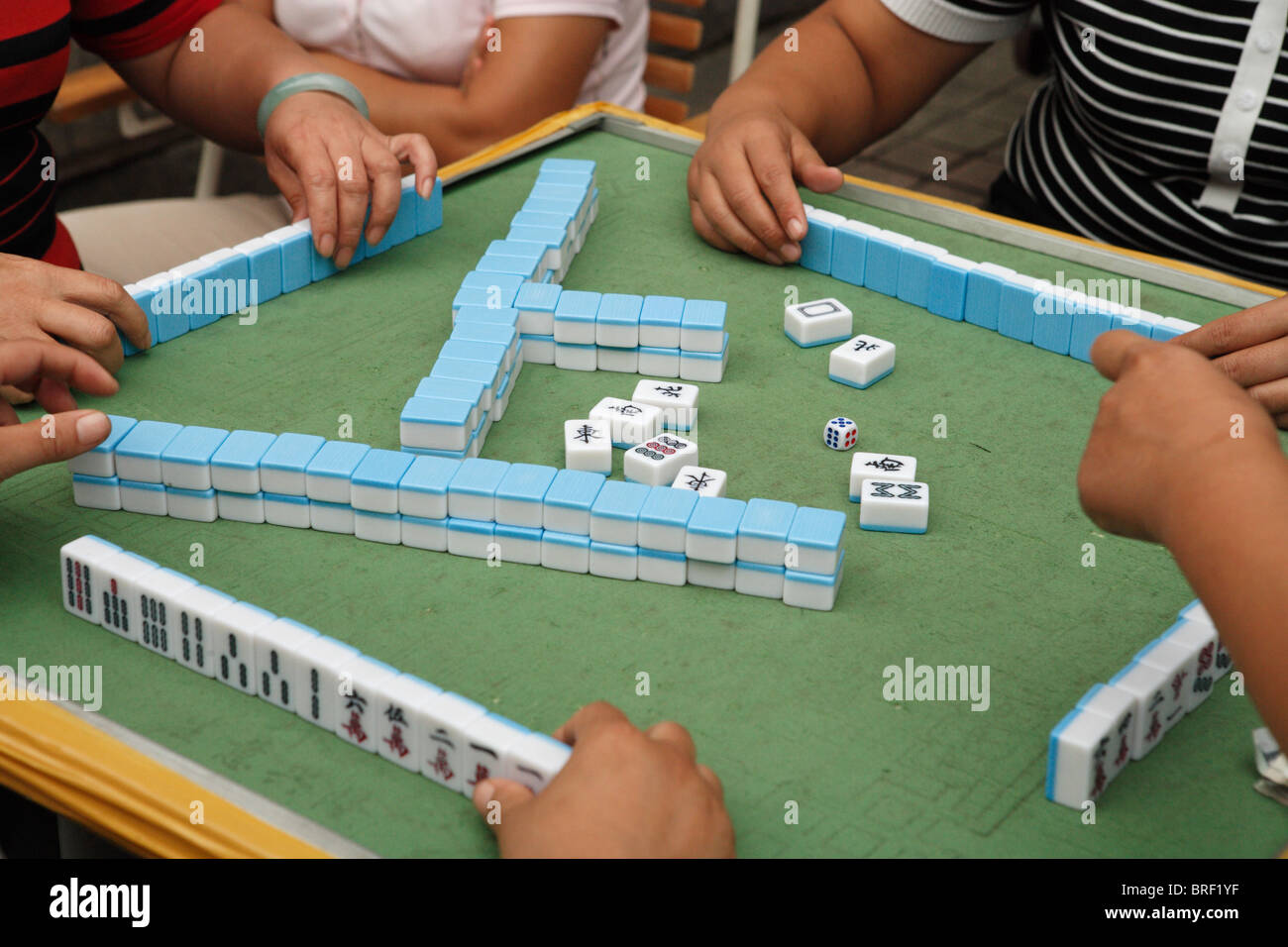 A Mahjong game in progress on a street in Shanghai, China Stock Photo ...