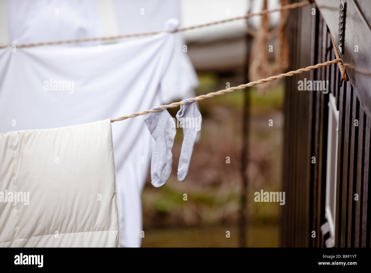 two small child's socks and linen hanging for drying. horizontal shot Stock Photo