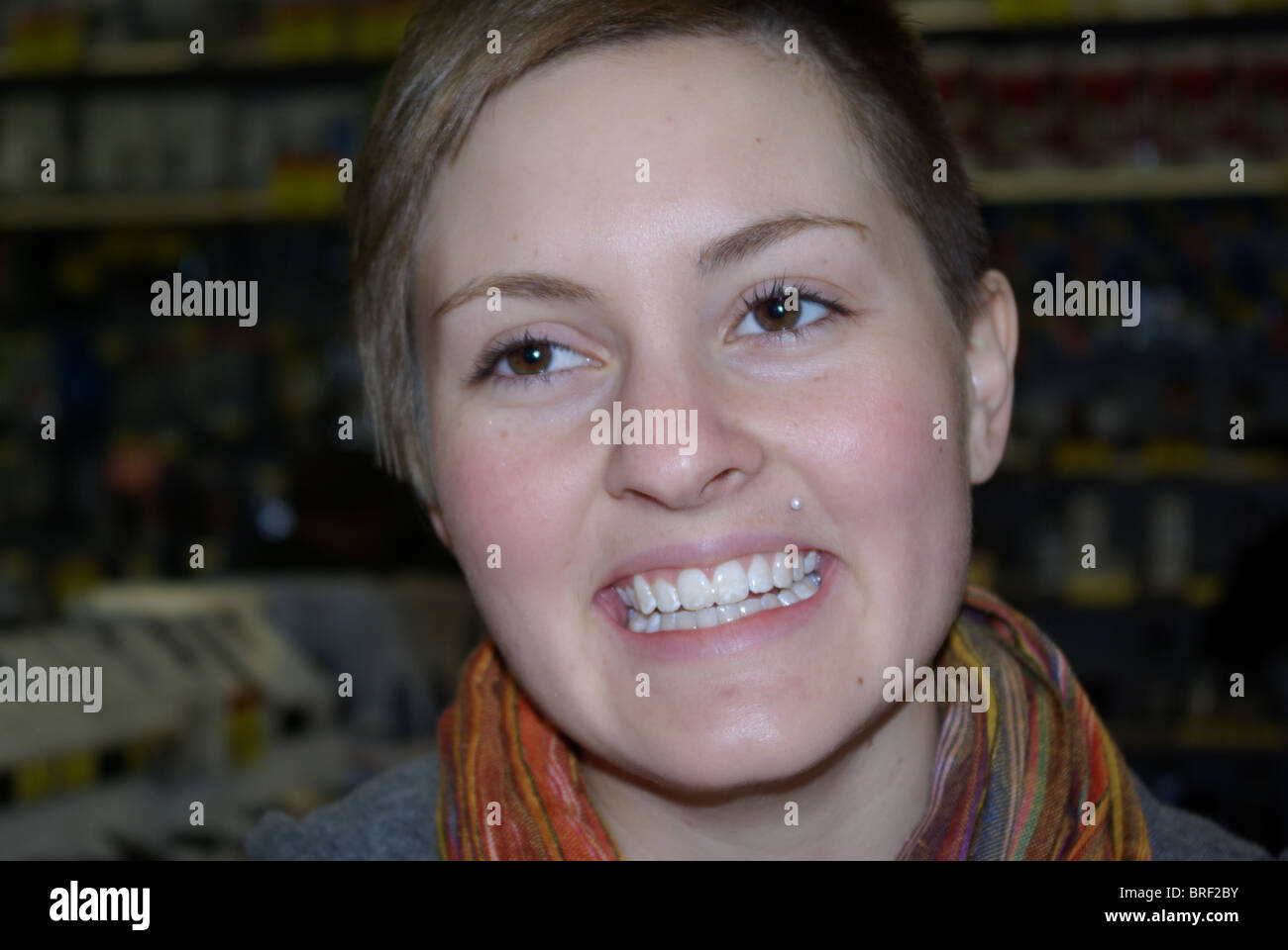 Young woman with beautiful healthy-looking skin smiling off to distance. Stock Photo