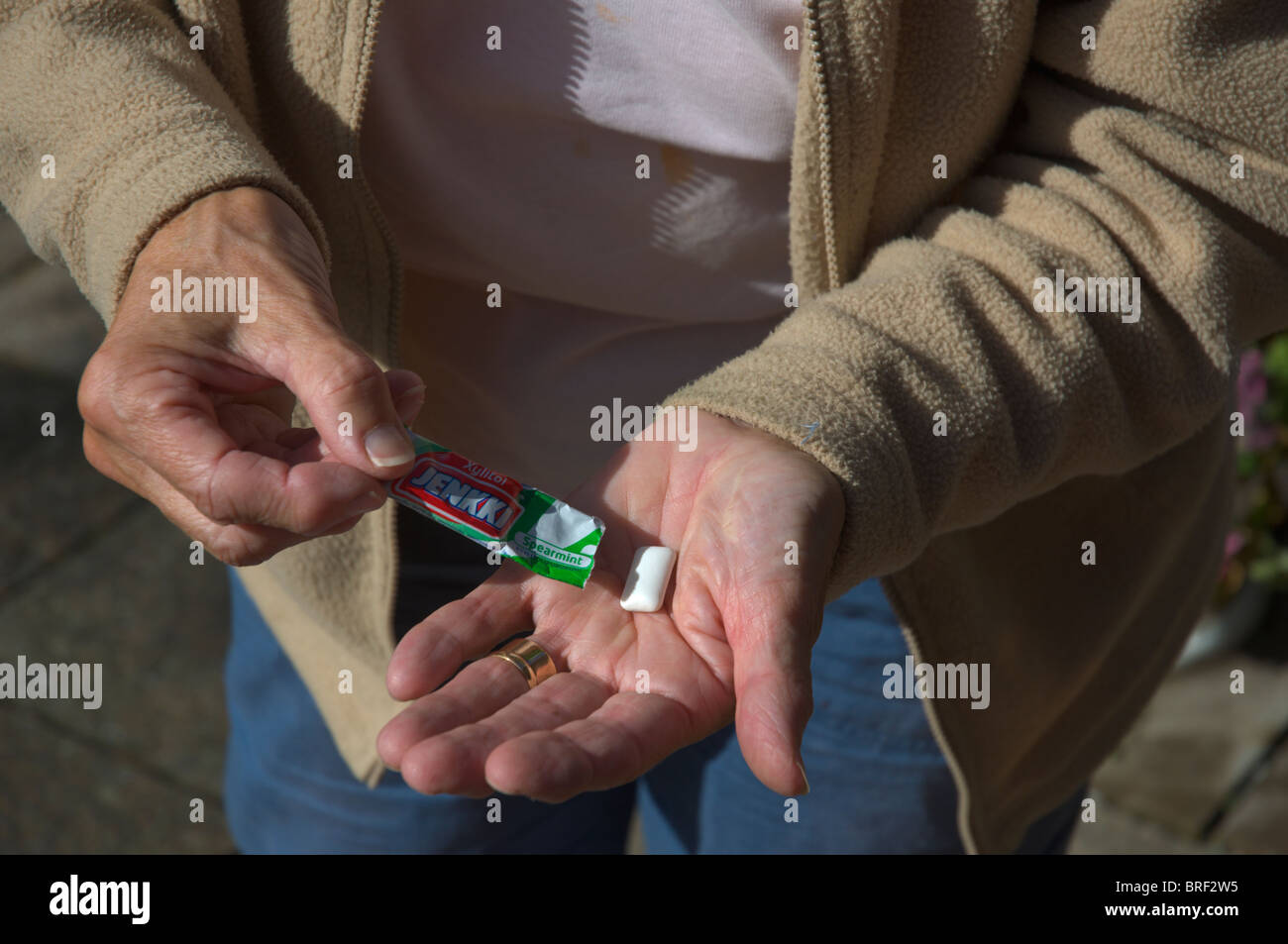 Senior woman with Jenkki Finnish chewing gum with Xylitol sweetener