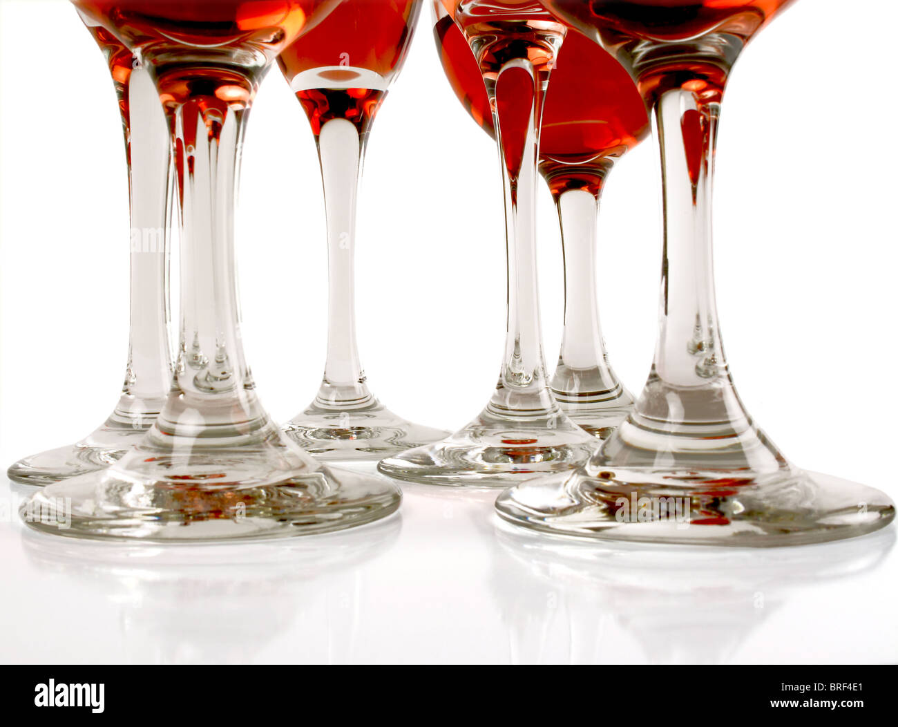 Six wine glass stems with red wine visible in the cups Stock Photo Alamy