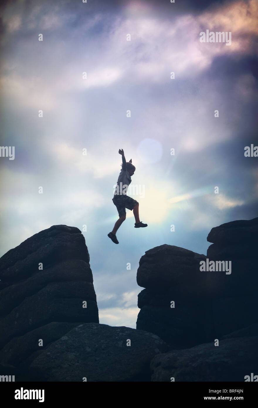 boy jumping on the rocks Stock Photo