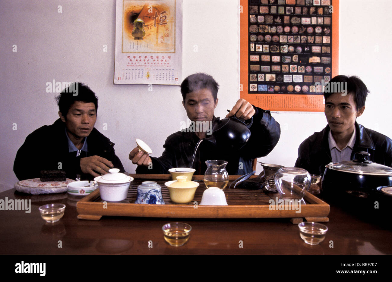 Luo Ming Wei (center), with his brothers carefully sample the tea that ...