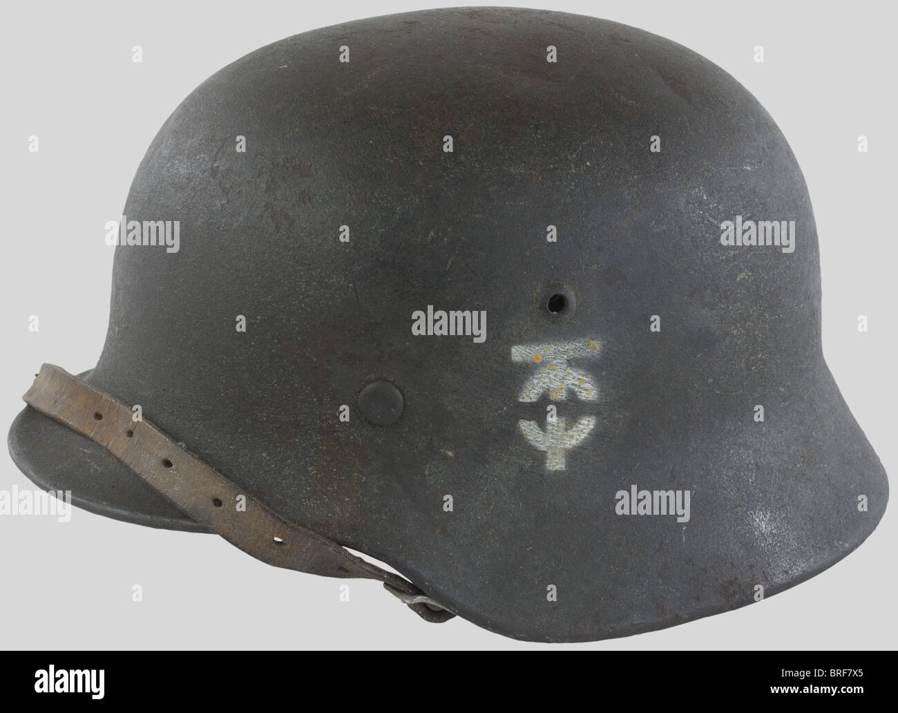 A M35/40 steel helmet of the organization TODT, complete with its liner and chinstrap. Insignia locally stenciled with white paint and showing the interlaced letters 'O' and 'T'. Compare 'Le casque allemand' (the german helmet), special edition from 'La gazette des Uniformes', page 38., historic, historical, 1930s, 1930s, 20th century, object, objects, stills, clipping, clippings, cut out, cut-out, cut-outs, Stock Photo