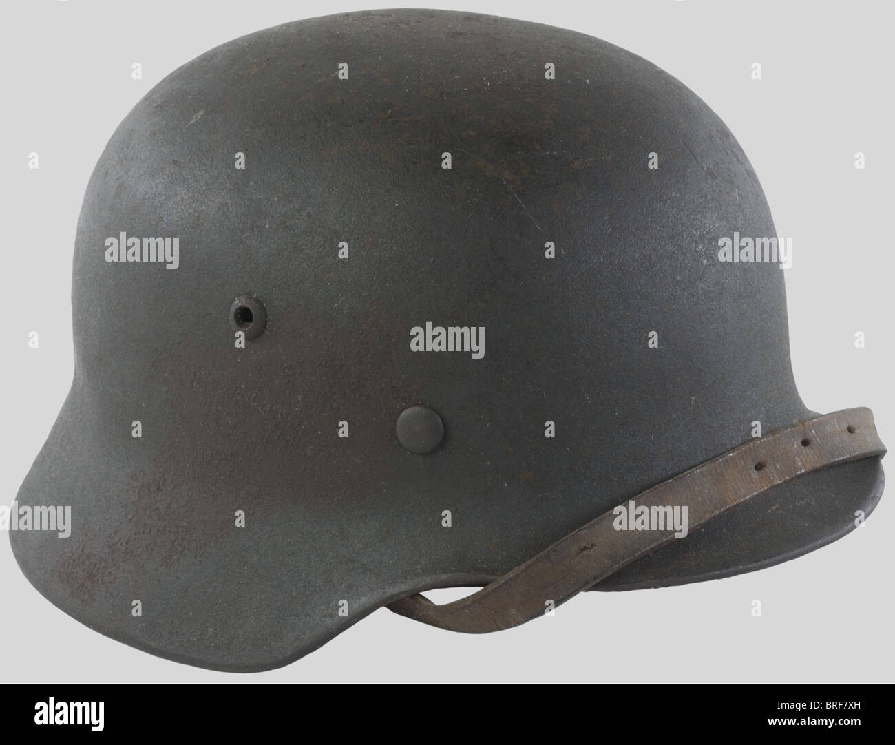 A M35/40 steel helmet of the organization TODT, complete with its liner and chinstrap. Insignia locally stenciled with white paint and showing the interlaced letters 'O' and 'T'. Compare 'Le casque allemand' (the german helmet), special edition from 'La gazette des Uniformes', page 38., historic, historical, 1930s, 1930s, 20th century, object, objects, stills, clipping, clippings, cut out, cut-out, cut-outs, Stock Photo