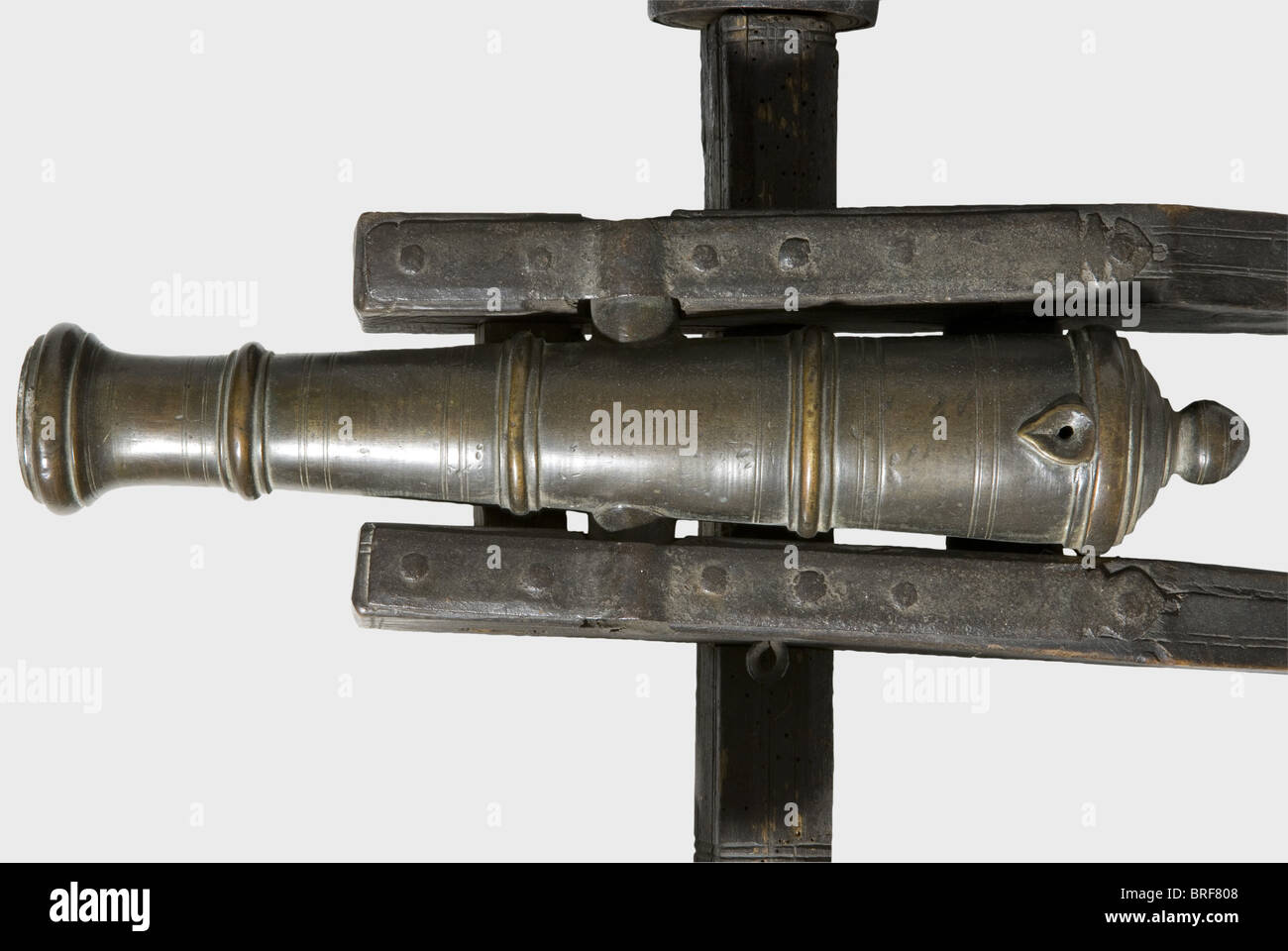 A model of a field cannon, 17th/18th century. Slender bronze barrel in 27 mm calibre with a cannon muzzle, two side-mounted trunnions, and a touchhole in a heart-shaped depression on top. Wooden carriage (some worm damage) with iron fittings and iron mounted wheels with spokes. Barrel length 39 cm. Total length 78 cm. historic, historical,, 18th century, 17th century, cannon, cannons, artillery, firearm, fire arm, firearms, fire arms, weapons, arms, weapon, arm, fighting device, military, militaria, object, objects, stills, clipping, clippings, cut out, cut-out, Stock Photo