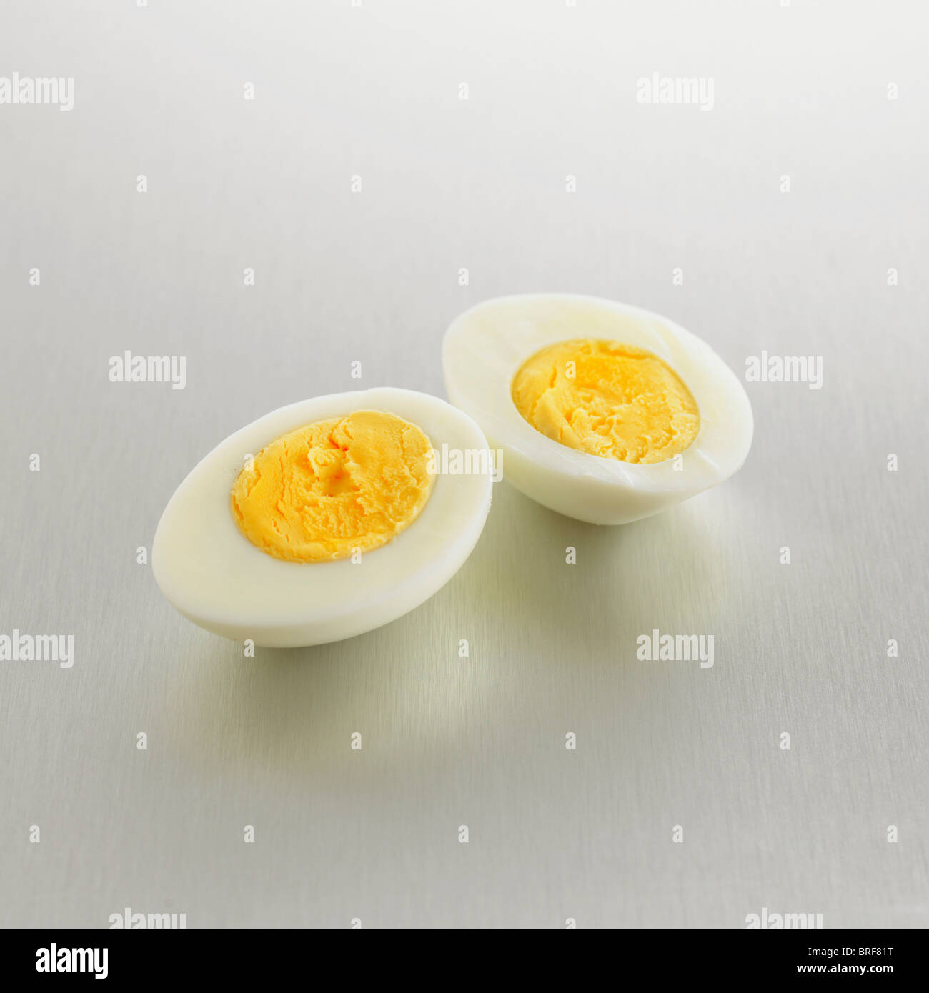 Two halves showing the yolks of a hard boiled egg Stock Photo
