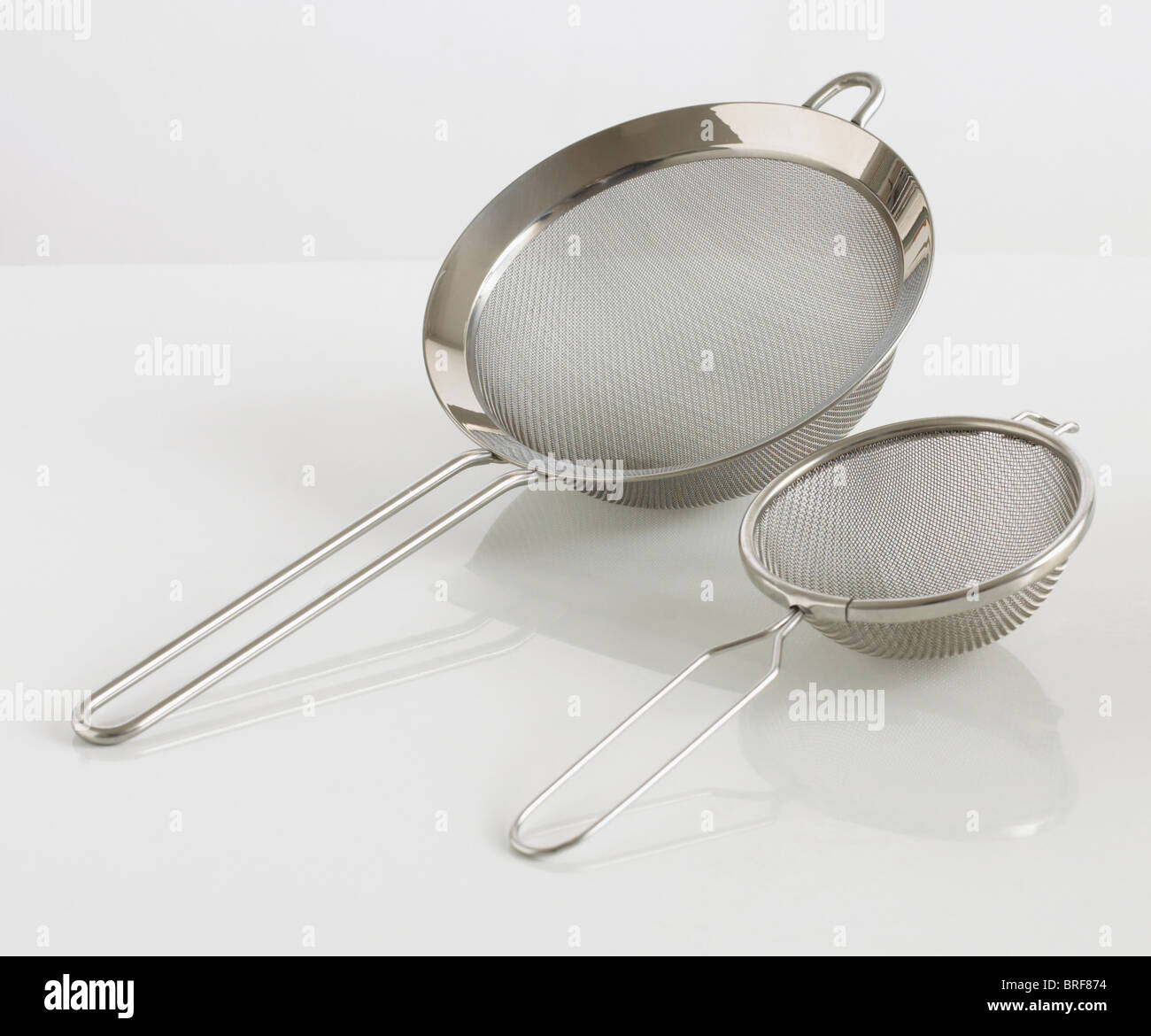 Stainless steel sieve and strainer on white background Stock Photo Alamy
