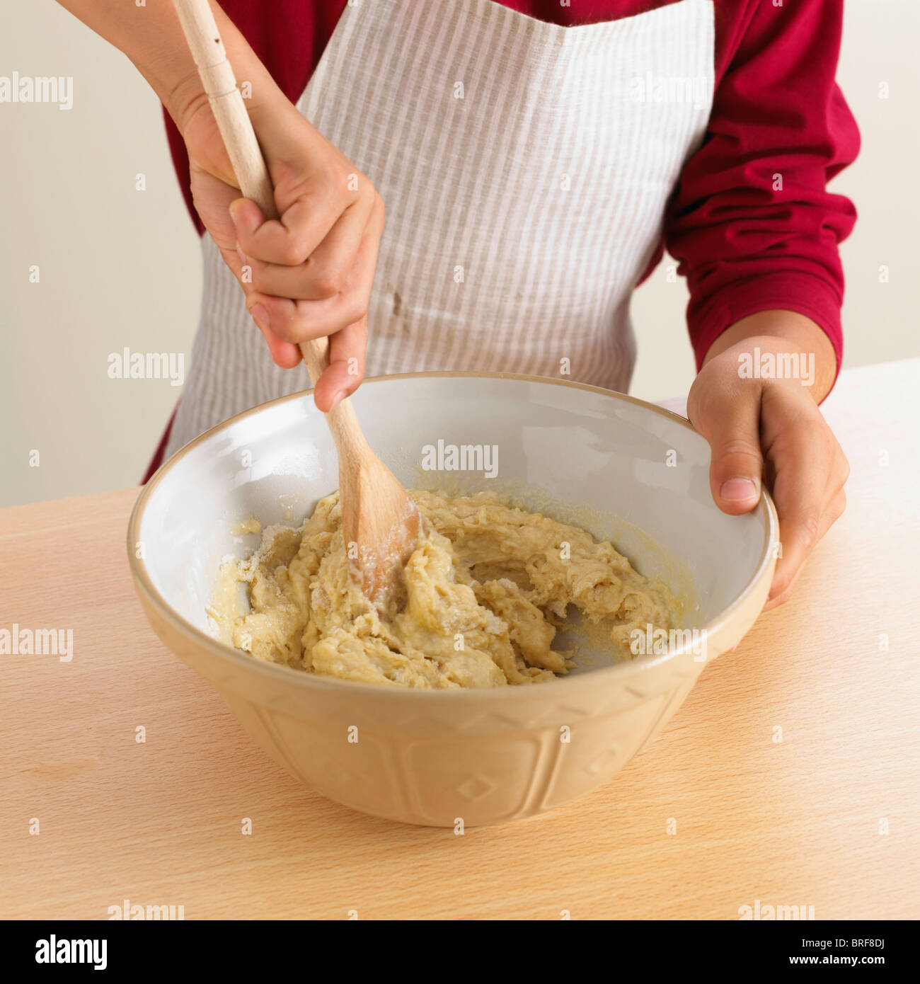 Man mixing cake batter with wooden spoon Stock Photo Alamy