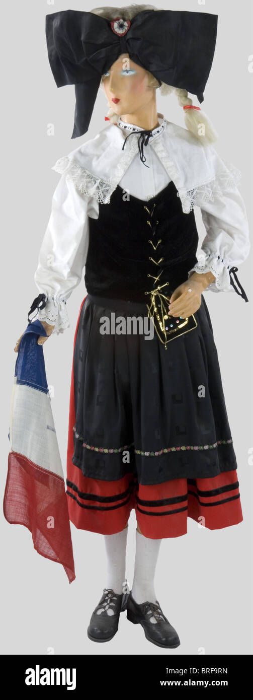 A child mannequin illustrating an Alsatian, wearing the traditional dress, complete with headgear, skirt and shoes. Very nice evocation., historic, historical, people, 20th century, object, objects, stills, clipping, clippings, cut out, cut-out, cut-outs, utensil, piece of equipment, utensils, item, items, Stock Photo