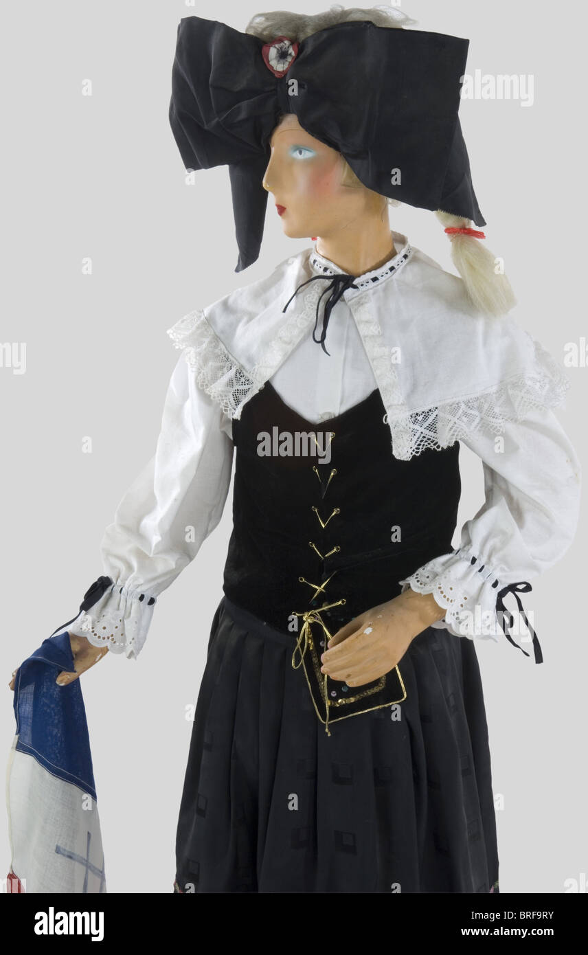 A child mannequin illustrating an Alsatian, wearing the traditional dress, complete with headgear, skirt and shoes. Very nice evocation., historic, historical, people, 20th century, object, objects, stills, clipping, clippings, cut out, cut-out, cut-outs, utensil, piece of equipment, utensils, item, items, Stock Photo