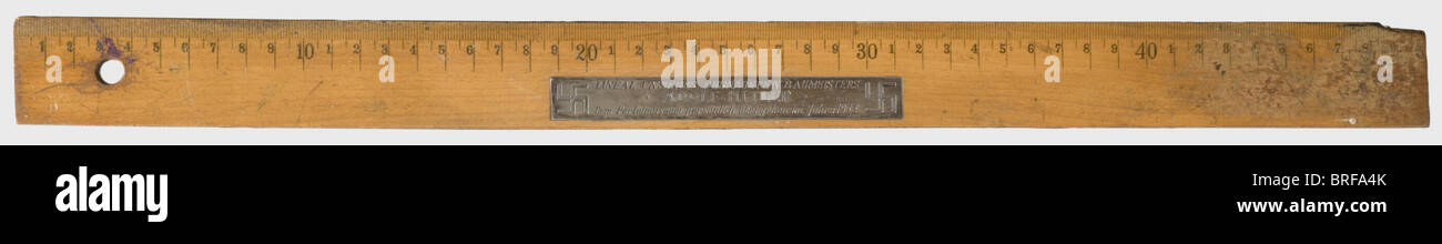 Adolf Hitler - a personal ruler., 50 cm wooden ruler with signs of wear, slightly warped. The top bears an imposed silver plaque with the engraved dedication (transl.) 'Ruler of our gifted master builder Adolf Hitler - personally handed over to the Party Museum in 1933' flanked by swastikas. The Party Museum was initially made up of the Rehse Collection acquired by the NSDAP in 1929 and located in the cellar rooms of the Munich NSDAP headquarters, Schellingstraße 50. After moving to the basement of the Kaiserhof of the Munich Residence in 1935, however, it rece, Stock Photo