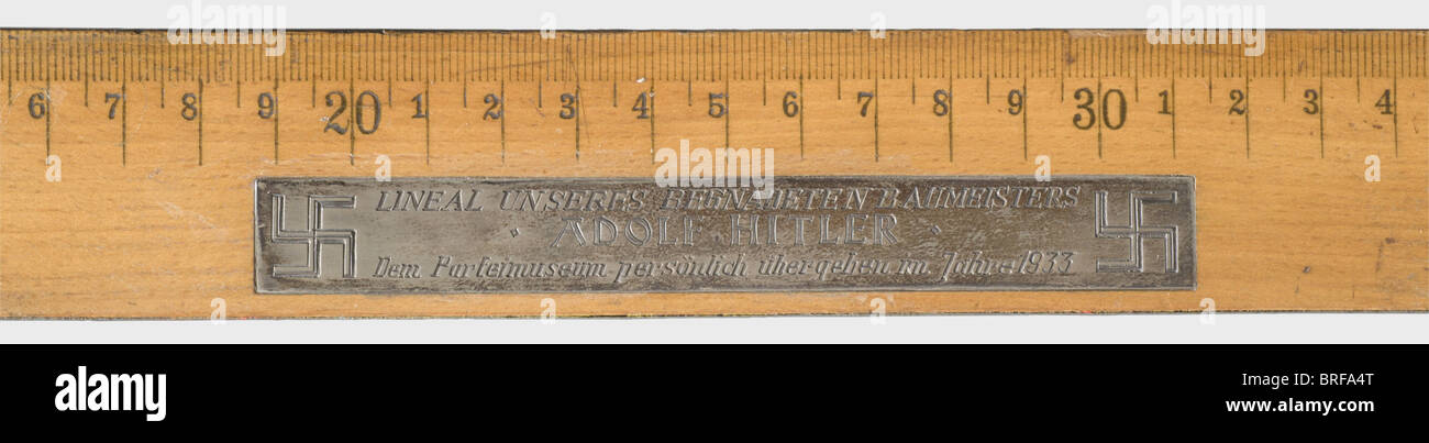 Adolf Hitler - a personal ruler., 50 cm wooden ruler with signs of wear, slightly warped. The top bears an imposed silver plaque with the engraved dedication (transl.) 'Ruler of our gifted master builder Adolf Hitler - personally handed over to the Party Museum in 1933' flanked by swastikas. The Party Museum was initially made up of the Rehse Collection acquired by the NSDAP in 1929 and located in the cellar rooms of the Munich NSDAP headquarters, Schellingstraße 50. After moving to the basement of the Kaiserhof of the Munich Residence in 1935, however, it rece, Stock Photo