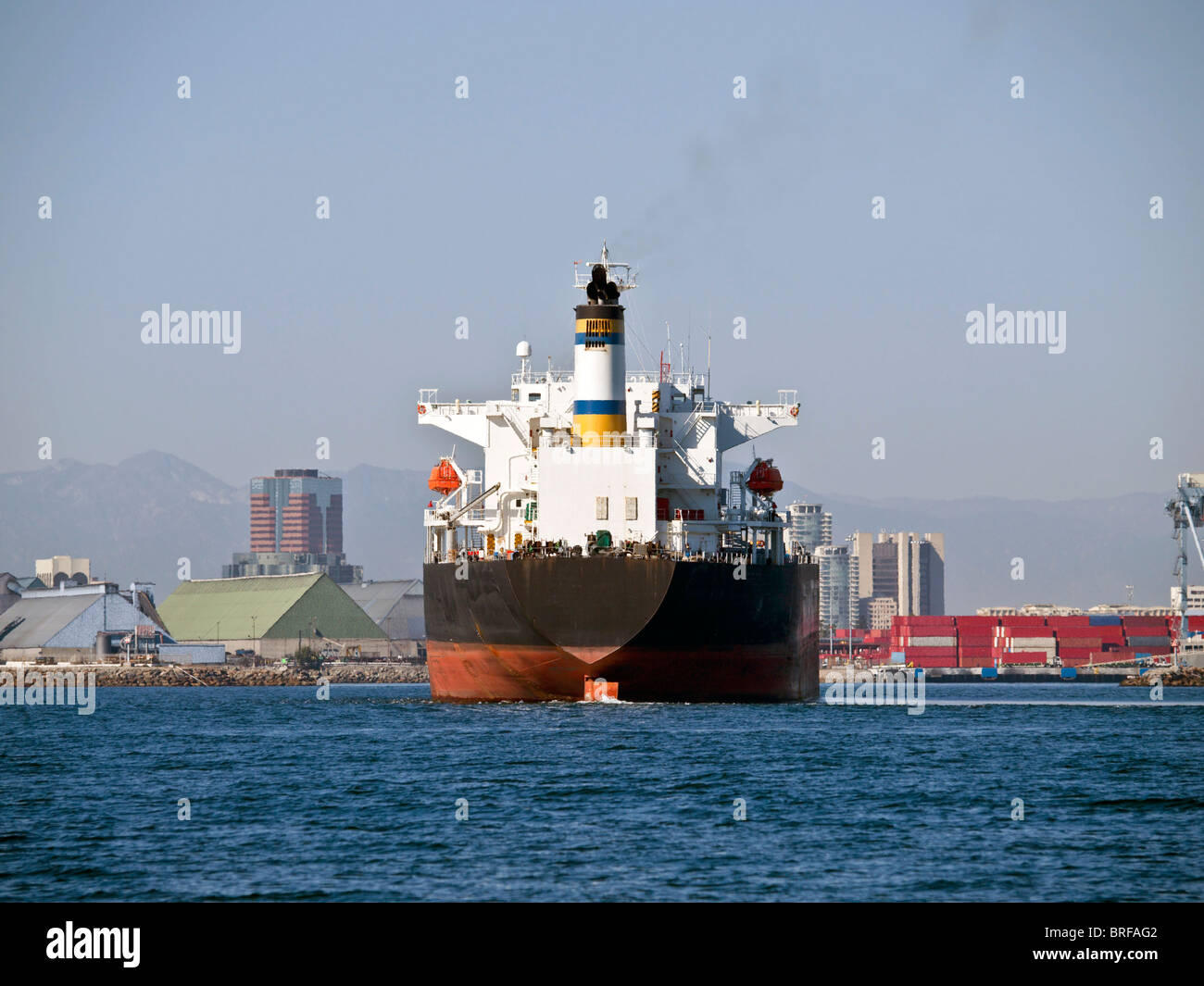 Giant oil tanker cruises towards Long Beach California in warm afternoon light.. Stock Photo