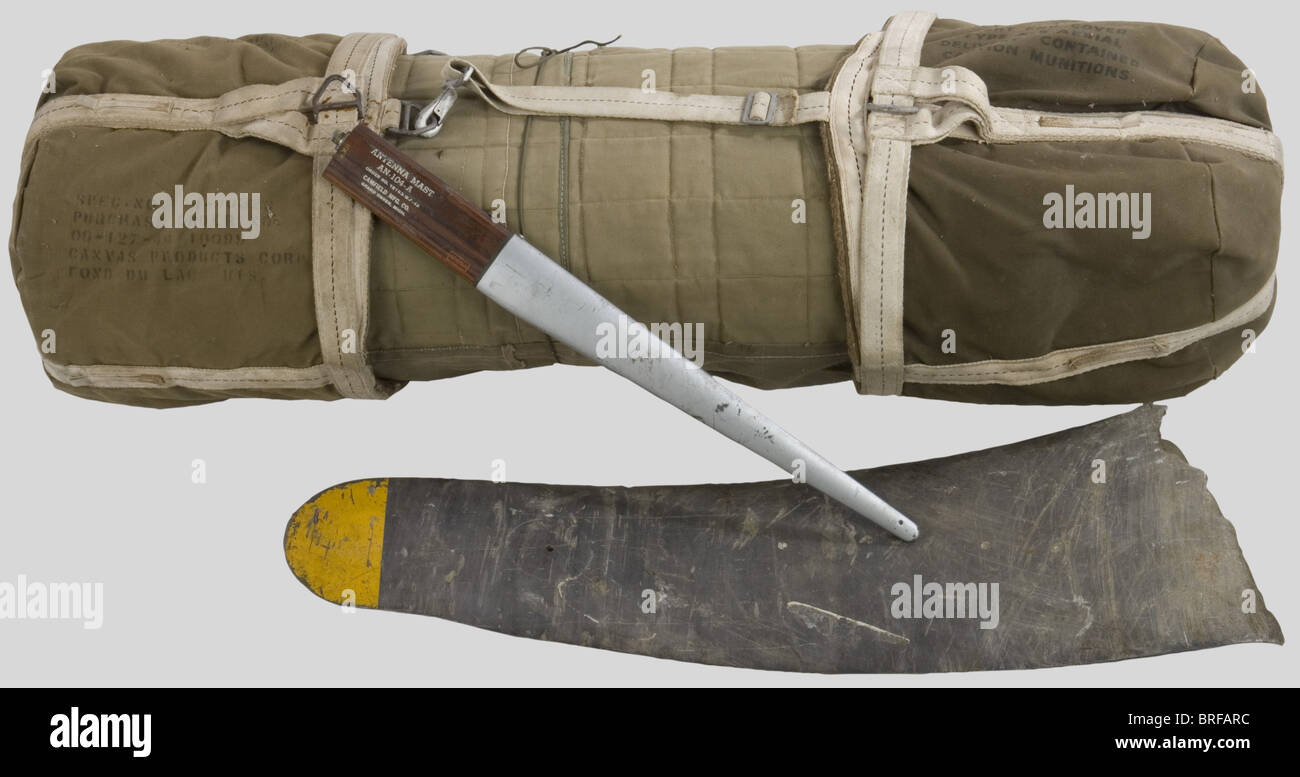 A US Army parachute container, in reinforced khaki material, complete with all straps and the parachute. Used for low level equipment delivery. Also, a fragment of a propeller blade, black with yellow tip (traces of rust) and a US ariel 'MAST AN-104-A' in wood and aluminium., historic, historical, 1930s, 1930s, 20th century, technical, technic, material, materials, device, devices, equipment, equipments, utensil, piece of equipment, utensils, technology, militaria, military, object, objects, stills, clipping, clippings, cut out, cut-out, cut-outs, firearm, fire, Stock Photo