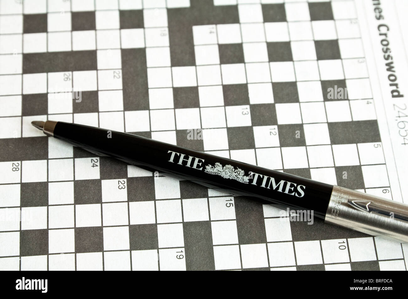Crossword, with a Parker - ballpoint pen, displaying The Times logo on the barrel. Stock Photo
