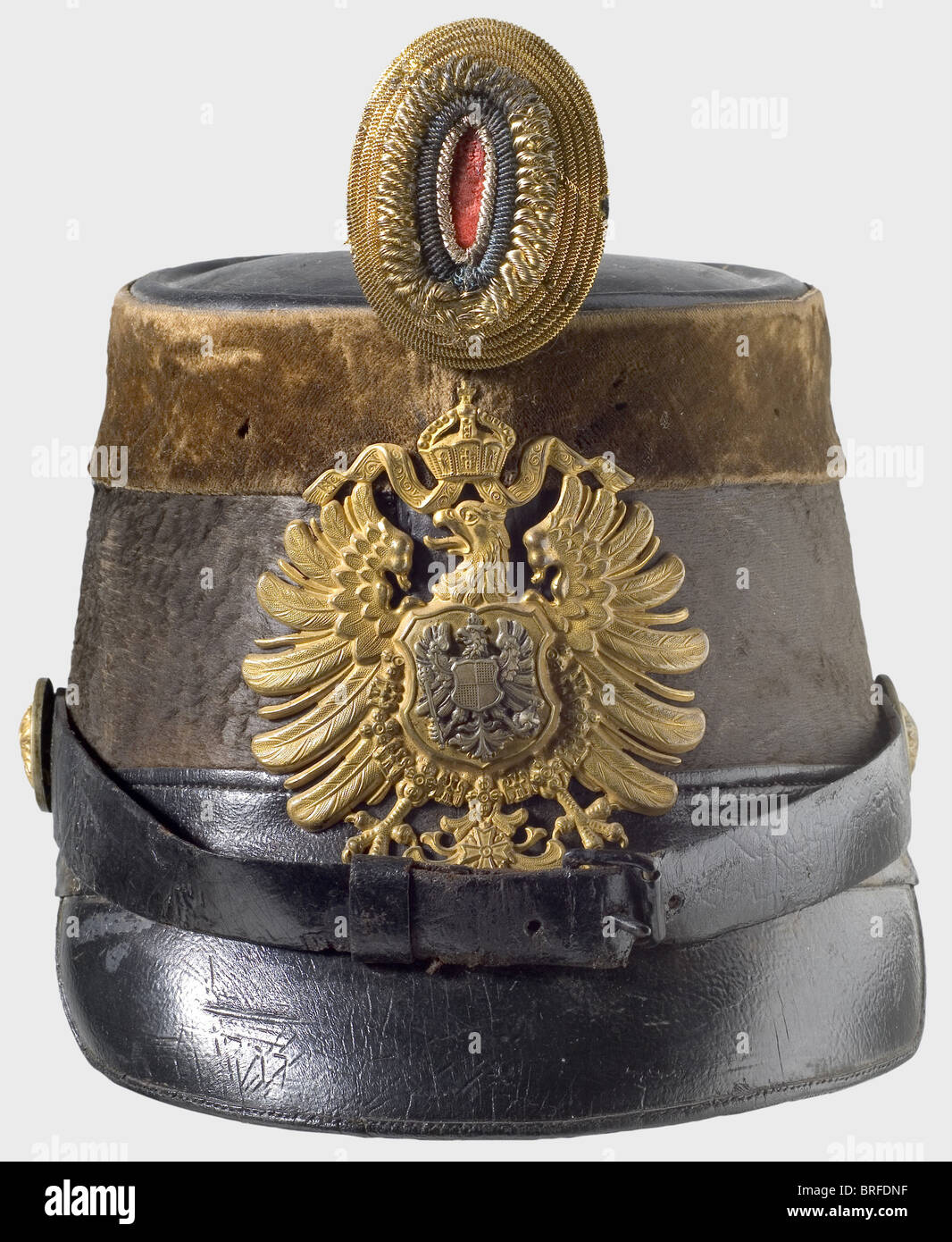 A shako for a customs official, circa 1880. Black mohair felt body, leather top, strap, and peak. A brown velvet band around the upper edge. Gilded imperial eagle plate with a seperate inescutcheon eagle overlay, Leather chinstraps on rosette buttons. Gold-black-red officer's field badge. (Feldzeichen). Lining missing. historic, historical, 19th century, German Empire, Germany, Imperial, object, objects, stills, clipping, cut out, cut-out, cut-outs, militaria, weapon, arms, weapons, arms, uniform, piece, pieces, Stock Photo