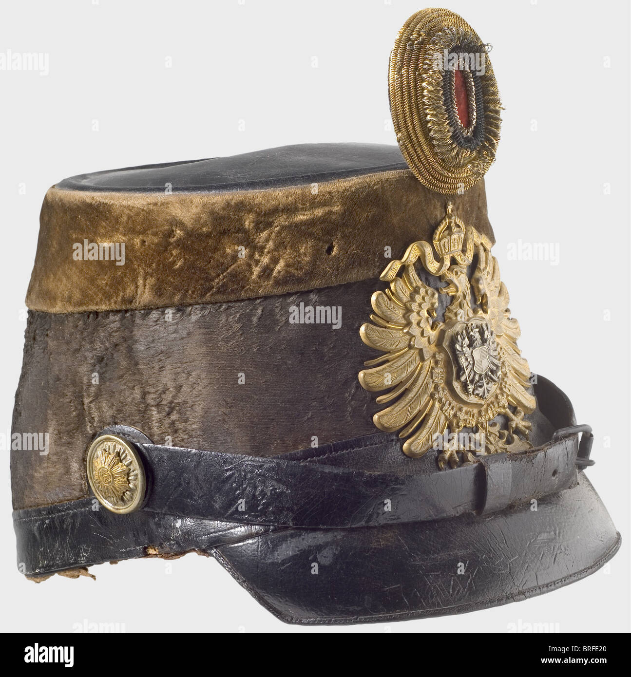 A shako for a customs official, circa 1880. Black mohair felt body, leather top, strap, and peak. A brown velvet band around the upper edge. Gilded imperial eagle plate with a seperate inescutcheon eagle overlay, Leather chinstraps on rosette buttons. Gold-black-red officer's field badge. (Feldzeichen). Lining missing. historic, historical, 19th century, German Empire, Germany, Imperial, object, objects, stills, clipping, cut out, cut-out, cut-outs, militaria, weapon, arms, weapons, arms, uniform, piece, pieces, Stock Photo