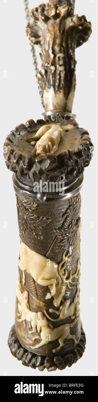 A carved staghorn pipe, Meiningen, Thuringia, circa 1830. Staghorn with silver mountings. Surrounded by finely carved, hunting scenes of riders, stag, and hounds in front of a forest backdrop. A couchant hunting hound on the lid. The stem made of staghorn segments with an amber mouthpiece and an attached silver chain. Height of the pipe bowl 11 cm. It comes with a leather tobacco pouch with top and sides stamped with hunting designs. Height 13.5 cm. Stylistically, the pipe is to be ascribed to the work of the Meiningen Master Leberecht Schulz and his son. Cf. H, Stock Photo