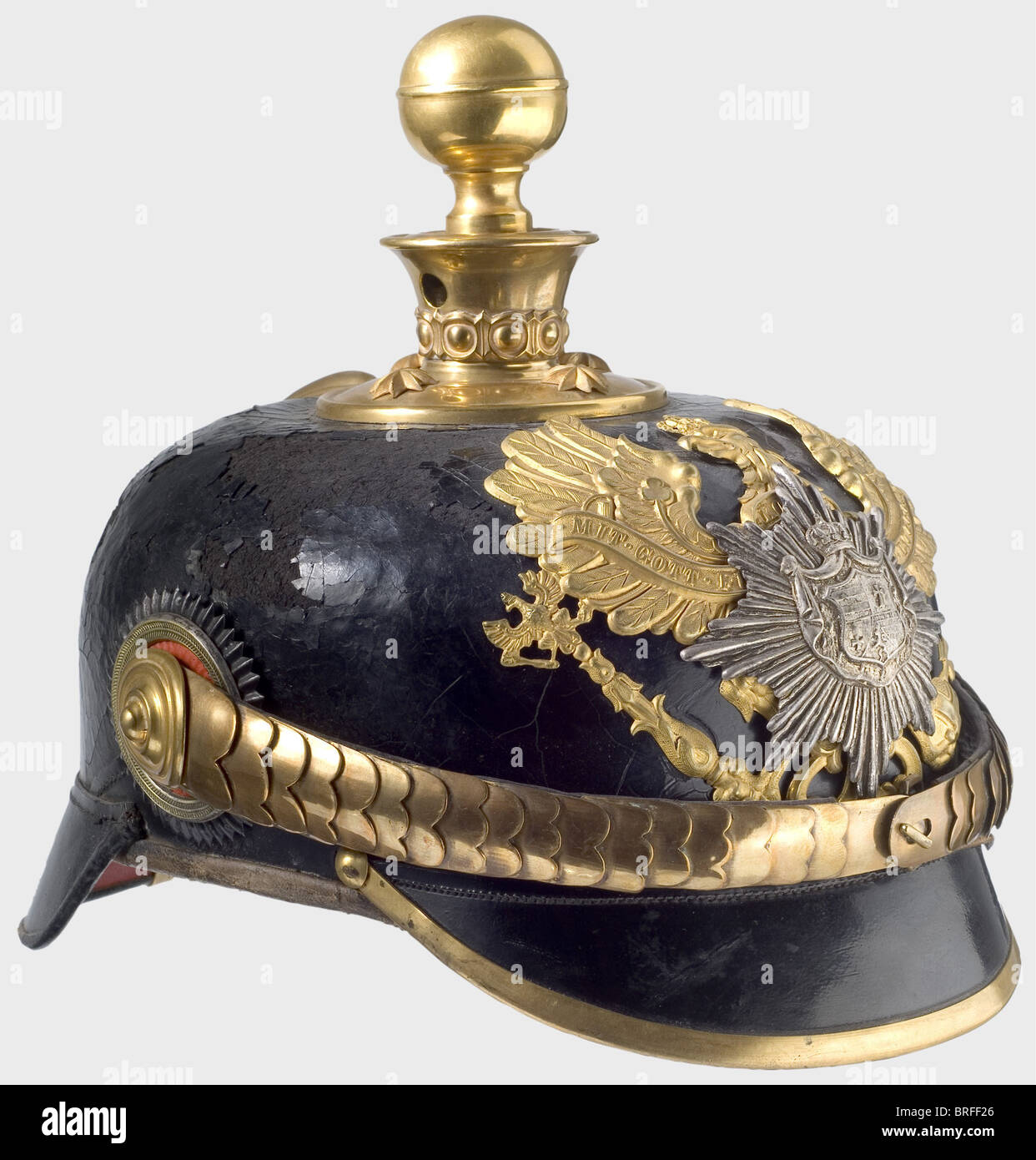 A model 91 helmet for officers, of the II or III Battery of the East Frisian Field Artillery Regiment No. 62. Black-lacquered leather skull (major imperfections) with gilded mountings. A silver star with the national coat of arms superimposed on the line unit eagle. Officer cockades. Reddish, ribbed silk lining. historic, historical, 19th century, helmet, helmets, headgear, headgears, protection, protective, uniform, uniforms, utensil, piece of equipment, utensils, outfit, outfits, headpiece, headpieces, object, objects, stills, clipping, clippings, cut out, cu, Stock Photo