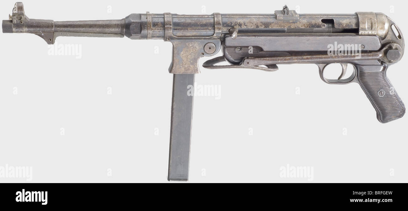 A submachine gun mod.40(MP 40),code '122',calibre 9 mm Parabellum,no.7603a.Completely matching numbers.Good rifling,but needs cleaning.32 shots.On the housing marked 'MP 40 / 122 / 40',therefore produced at Haenel's,Suhl in 1940.Various acceptance marks eagle/'37'.Smooth magazine catch.Original finish very spotty,partly in a brown patina and worn patches.Stock and grip panels made of brownish black bakelite with scratches.Incorrect but apt,blued magazine.Untouched collector's item in original condition.Careful cleaning will improve looks.,Additional-Rights-Clearences-Not Available Stock Photo
