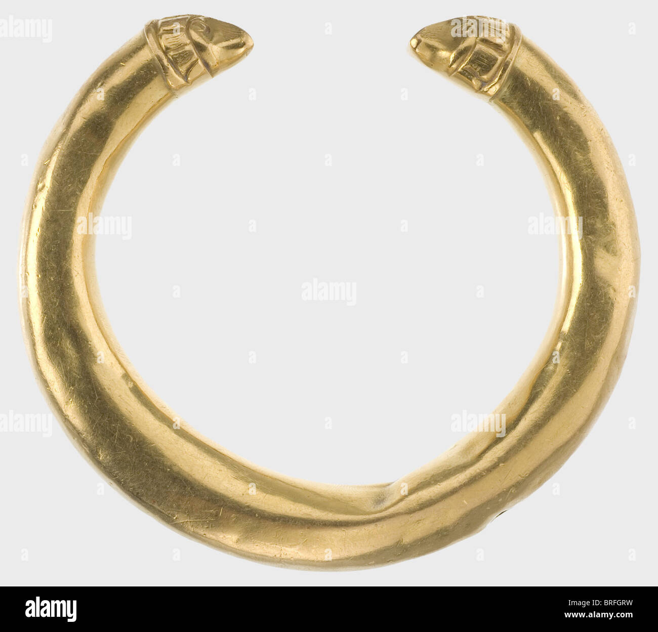A golden Hellenistic bracelet, 3rd/2nd century B.C. Hollow, double tapered bracelet with stylized animal head finials. Somewhat dented and with a slight kink in the middle. Diameter 8.5 cm. Weight 78.5 g. historic, historical, ancient world, jewellery, jewelry, object, objects, stills, clipping, clippings, cut out, cut-out, cut-outs, Additional-Rights-Clearences-Not Available Stock Photo