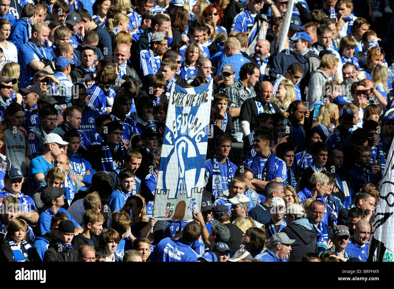 spectators in the Arena auf Schalke support german football club Schalke 04 with large banners in Gelsenkirchen, Germany Stock Photo