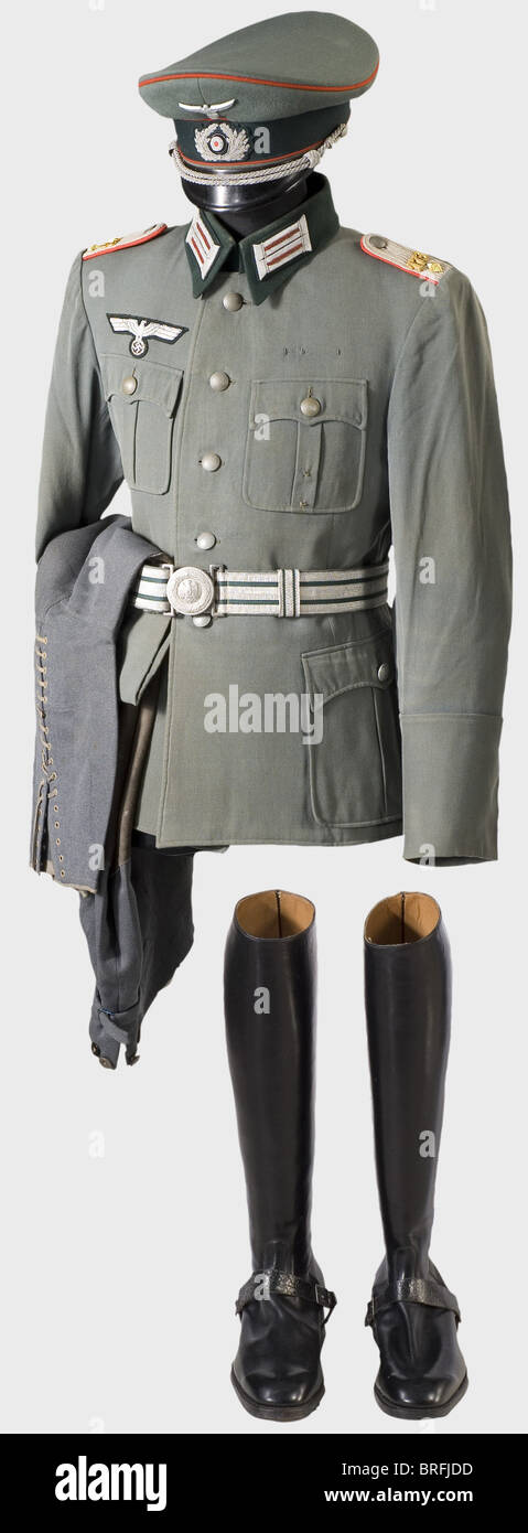 A walking out uniform for a First Lieutenant,of the 173rd Artillery Regiment(Amberg). A field grey cloth visor cap with dark green cap band,red piping,silver-embroidered oak leaf wreath,metal eagle,and silver cap cord. Golden silk lining with the maker's label,"Erel Sonderklasse Extra"(Erel Special Class Extra). Brown leather sweatband. Traces of wear. A light,field grey,gabardine tunic with dark green collar,silver-embroidered eagle(corroded),collar patches,sewn-on shoulder boards,and green silk lining. Dress belt with aluminium buckle(one slid,Additional-Rights-Clearences-Not Available Stock Photo