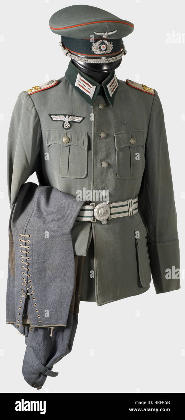A walking out uniform for a First Lieutenant,of the 173rd Artillery Regiment(Amberg). A field grey cloth visor cap with dark green cap band,red piping,silver-embroidered oak leaf wreath,metal eagle,and silver cap cord. Golden silk lining with the maker's label,'Erel Sonderklasse Extra'(Erel Special Class Extra). Brown leather sweatband. Traces of wear. A light,field grey,gabardine tunic with dark green collar,silver-embroidered eagle(corroded),collar patches,sewn-on shoulder boards,and green silk lining. Dress belt with aluminium buckle(one slid,Additional-Rights-Clearences-Not Available Stock Photo