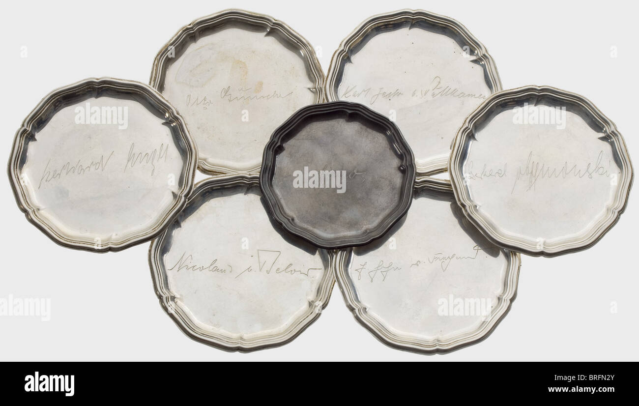 Richard Schulze-Kossens - seven silver saucers,from his legacy,with the engraved names of the adjutants from Hitler: 'Otto Günsche',SS-Sturmbannführer and personal adjutant,'Nicolas von Below',Colonel and Luftwaffe adjutant,'Karl Jesko von Puttkamer',Rear Admiral and naval adjutant,'Gerhard Engel',Brigadier General and army adjutant,'Ernst John von Freyend',Major and Keitel's adjutant at the OKW(Wehrmacht HQ),along with two others. Diameters ca. 9 to 11 cm. Total weight 312 g. historic,historical,1930s,1930s,20th century,Waffen-SS,armed divis,Additional-Rights-Clearences-Not Available Stock Photo
