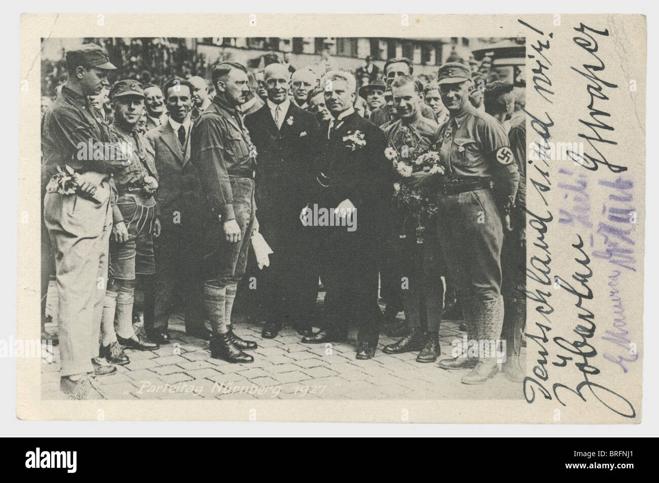 Hermine Hoffmann - picture postcard from the Reich Party Congress 1927 with the signatures of Adolf Hitler,Rudolf Heß,Hermann Esser,Joseph Goebbels,Gottfried Feder,Alfred Rosenberg,F.X. Schwarz,Julius Streicher,Arthur Dinter,Adolf Hühnlein,Walte,signed in ink,pencil,and indelible pencil. Picture postcard(transl.)'Party congress Nuremberg 1927',a group picture showing Hitler wearing lederhosen,Gottfried Feder and Arthur Dinter in the centre,flanked by Goebbels,Hühnlein and other signers. On the edge written in ink(transl.)'We are Germany! Zö,Additional-Rights-Clearences-Not Available Stock Photo
