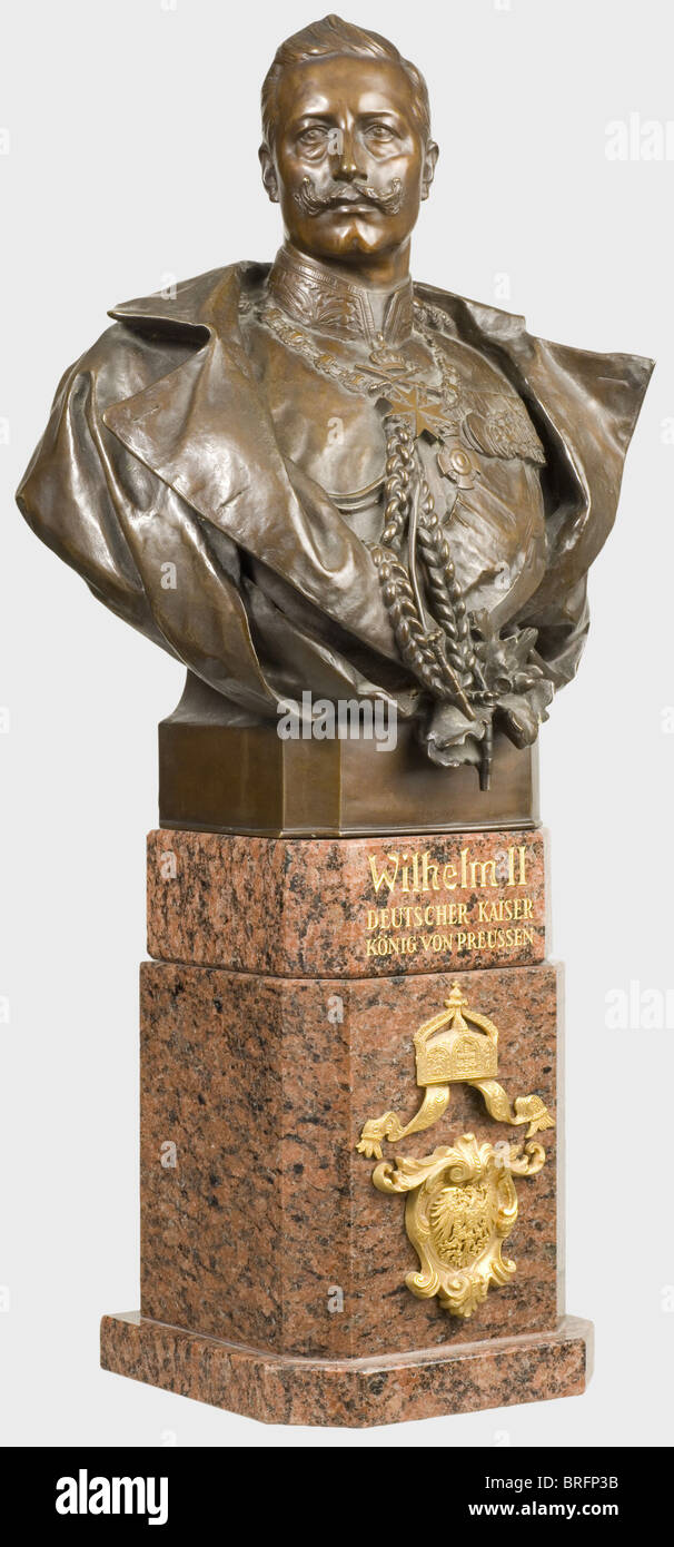 Gerhard Janensch (1860 - 1933) - bronze bust of Kaiser Wilhelm II., The Kaiser in the uniform of a general with open greatcoat. Base signed 'Prof. G. Janensch fec.' and foundry name Gladenbeck & Sohn, Berlin. Stepped porphyry plynth with gilt inscription, the emperor's crown and imperial coat of arms both in gilt bronze. Very elaborate work of high quality. Height 74 cm. The Berlin sculptor Gerhard Janensch not only created a number of sculptures and busts for public places in Berlin, he also made portraits of famous contemporaries (cf. Thieme-Becker, Vol. XVII, Stock Photo