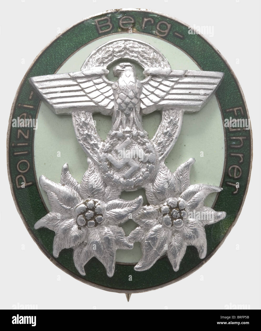 A Police Mountain Leader Badge, non-ferrous metal, silvered with light green enamel, the inscription ring with dark green transparent enamel (slight spidering), three-rivet aluminium appliqués, vertical wire attachment pin (OEK 3663). historic, historical, 1930s, 1930s, 20th century, awards, award, German Reich, Third Reich, Nazi era, National Socialism, object, objects, stills, medal, decoration, medals, decorations, clipping, cut out, cut-out, cut-outs, honor, honour, National Socialist, Nazi, Nazi period, symbol, symbols, emblem, emblems, insignia, Additional-Rights-Clearences-Not Available Stock Photo