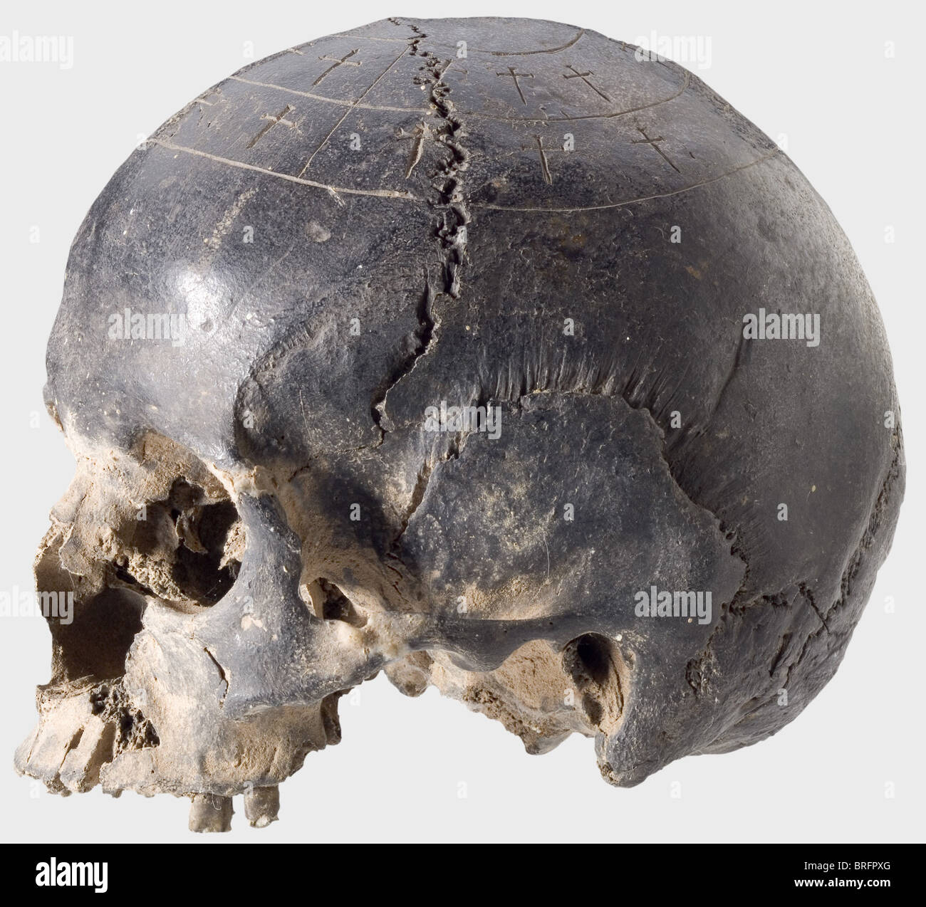 A German oath skull,16th - 17th century.Human skull missing the lower jaw.Dark patination with traces of use.The top of the skull shows two lines of engraved crosses surrounded by circumfences.Height 14 cm.The vehmic courts reached the height of their power in the 1st half of the 15th century,and in the growing uncertainty in justice took on more and more the character of strictly organised hidden bands of the 'wise men',who were bound by oath to their duty of complete secrecy.Although the vehmic courts never resorted to the use of torture,they spread,Additional-Rights-Clearences-Not Available Stock Photo