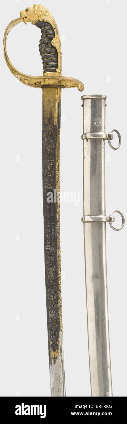 Ensign Carl von Grolmann - a magnificent presentation sabre from Prince Heinrich of Prussia,for service as a page during 1908 - 09.Lions head Hessian infantry officer's sabre.Pipe-backed blade with yelmen,half decorated with rich floral etching,and retaining some of the gilding.The reverse side displays a name cartouche,'Heinrich Prinz von Preussen' and the obverse side the dedication inscription,'Dem Fähnrich Carl von Grolmann für Pagendienst 1908-1909'(To Ensign Carl von Grolmann for Page Duty 1908-1909).The back is inscribed 'Ed.Schulze Inh.Herma,Additional-Rights-Clearences-Not Available Stock Photo