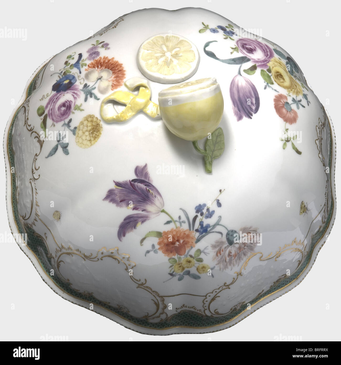 Friedrich II - General Joachim von Zieten(1699 - 1786)- a cloche,Meissen,circa 1760.Porcelain cloche,with a sliced lemon as a handle,hand-painted decorative flowers in colour,and a surrounding copper-green scalloped rim.Cartouches edged in gold with "Prussian-musical" decoration.An underglaze sword mark on the inside edge.Diameter 28.5 cm.Height 18 cm.The flower pattern with the green scalloped rim was specified for the Zieten service,which Frederick the Great presented to his Cavalry General von Zieten well before the Möllendorff Service.Cf.The,Additional-Rights-Clearences-Not Available Stock Photo