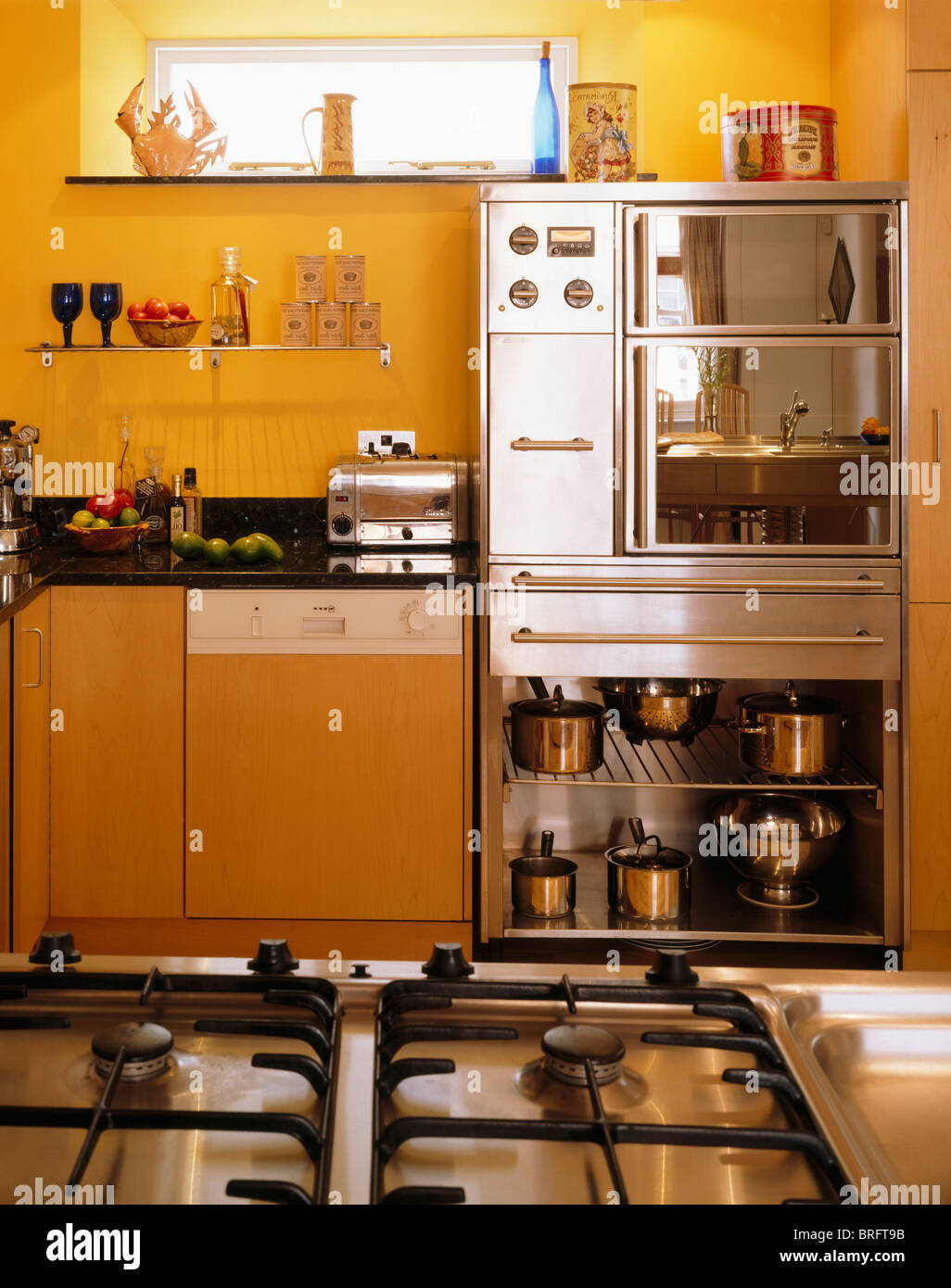 Pull out storage drawer with white dishes in modern kitchen Stock Photo -  Alamy