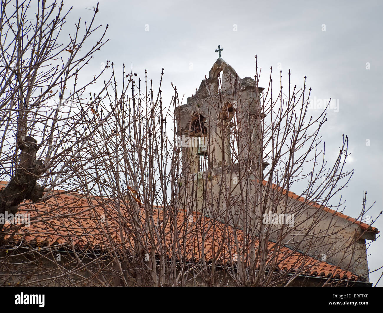 Old church tower in the cloudy winter day Stock Photo
