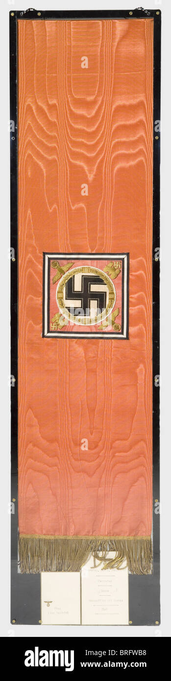 Adolf Hitler - a wreath ribbon for the funeral ceremonies for Reinhard Heydrich,on 9 June 1942 at the Mosaic Hall of the New Reich's Chancellery in Berlin.Red,watered ribbed silk with Hitler's personal heraldic eagle embroidered in gold over the stamped gold inscription.'Der Führer und Oberste Befehlhaber der Wehrmacht'(The Führer and Supreme Commander of the Wehrmacht).The opposite side displays Hitler's personal standard as supreme commander of the Wehrmacht embroidered in gold on silk.A gold fringe along the lower edge.Length ca.110 cm.Outstanding ,Additional-Rights-Clearences-Not Available Stock Photo