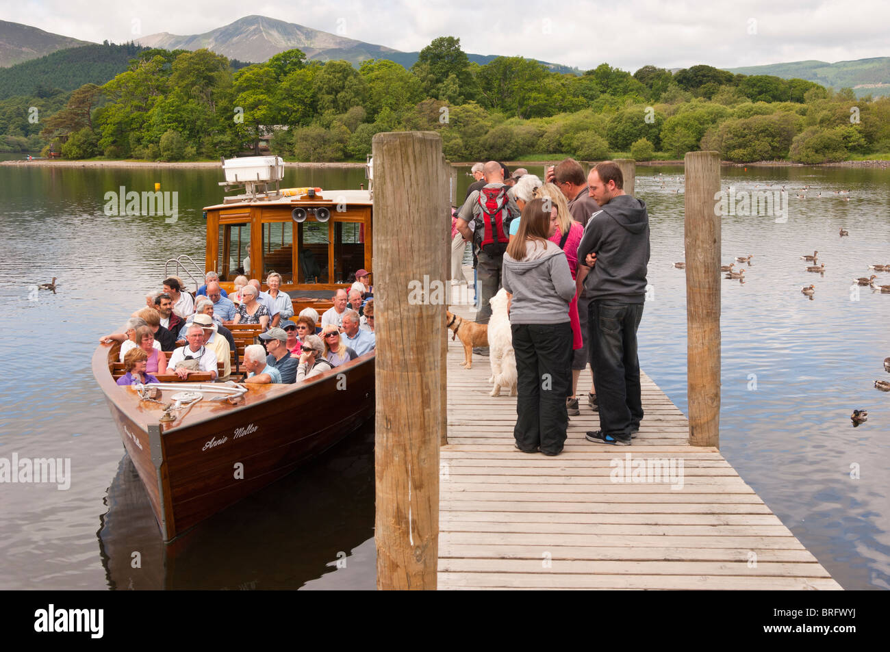 People queue for a boat trip at Derwent water at Keswick , Lake