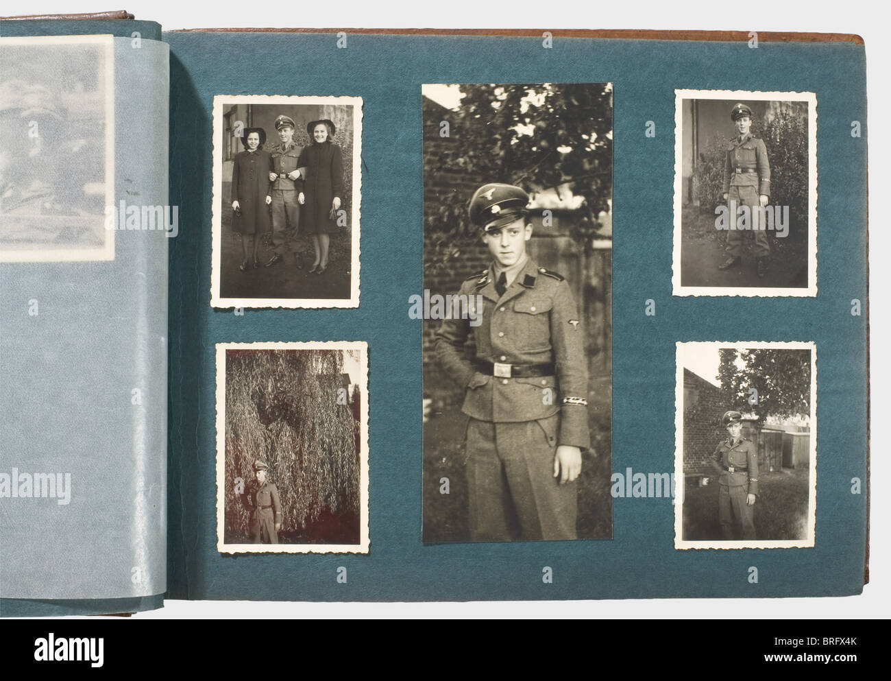 A private photo album,of a member of the SS-War Reporters,Company 5 Circa 100 photographs,mostly military,in a brown leather-bound album. After basic training in the SS,he was on his way in his own service vehicle to Russia,together with his cameraman Oberscharführer Hulle. Many photos show him and his fellow soldiers in camouflage uniform. Once Hulle,wearing his Iron Cross I,appears in the black panzer uniform. Sometimes,pictures show him wearing the sleeve band 'SS-Kriegsberichter'(SS-War Reporter). There are scenes of winter fighting,burning villa,Additional-Rights-Clearences-Not Available Stock Photo