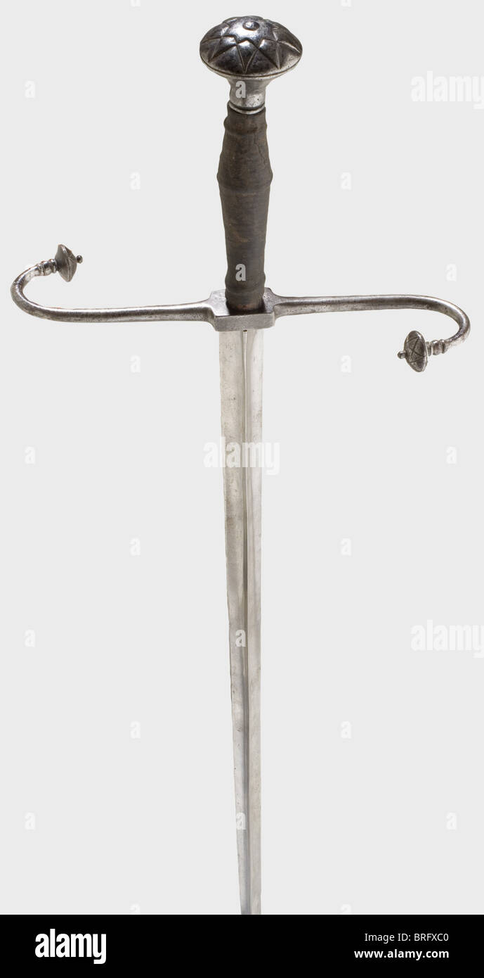 A German estoc, circa 1520 Long, triangular thrusting blade with curved, S-shaped quillons with lenticular finials cut as stars on the outside. Wooden grip with leather grip cover and an iron pommel, cut en suite. Length 138 cm., historic, historical, 16th century, sword, swords, weapons, arms, weapon, arm, fighting device, military, militaria, object, objects, stills, clipping, clippings, cut out, cut-out, cut-outs, melee weapon, melee weapons, metal, Additional-Rights-Clearences-Not Available Stock Photo