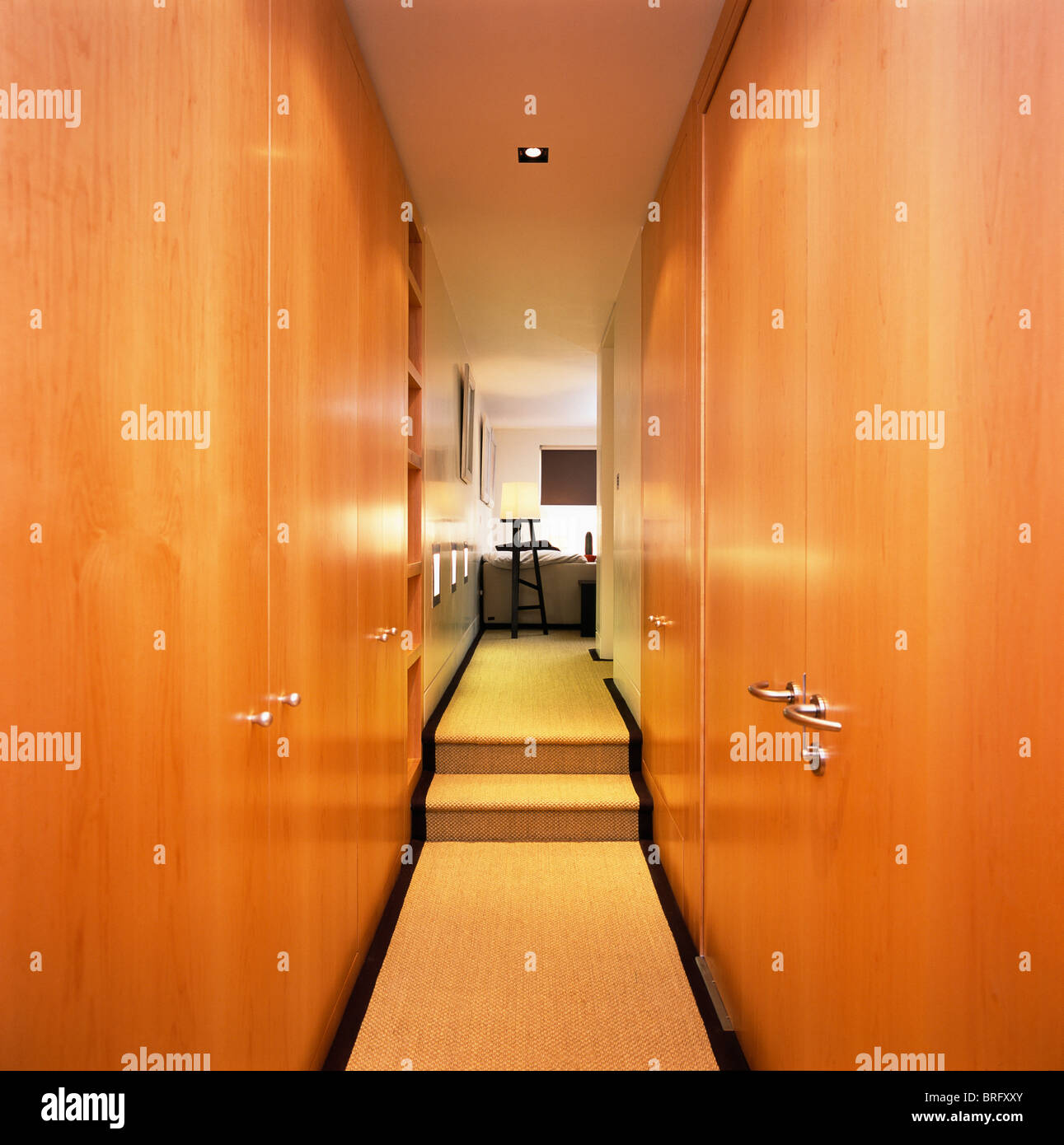 Fitted Wardrobes With Wood Doors On Either Side Of Narrow Modern