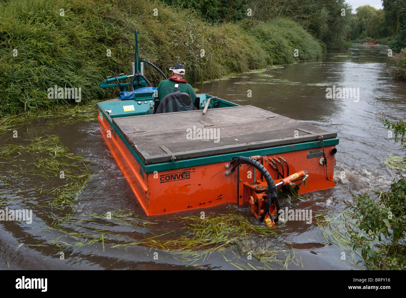 Weed cutting boat on the River Wesum at Fakenham, Norfolk Stock Photo