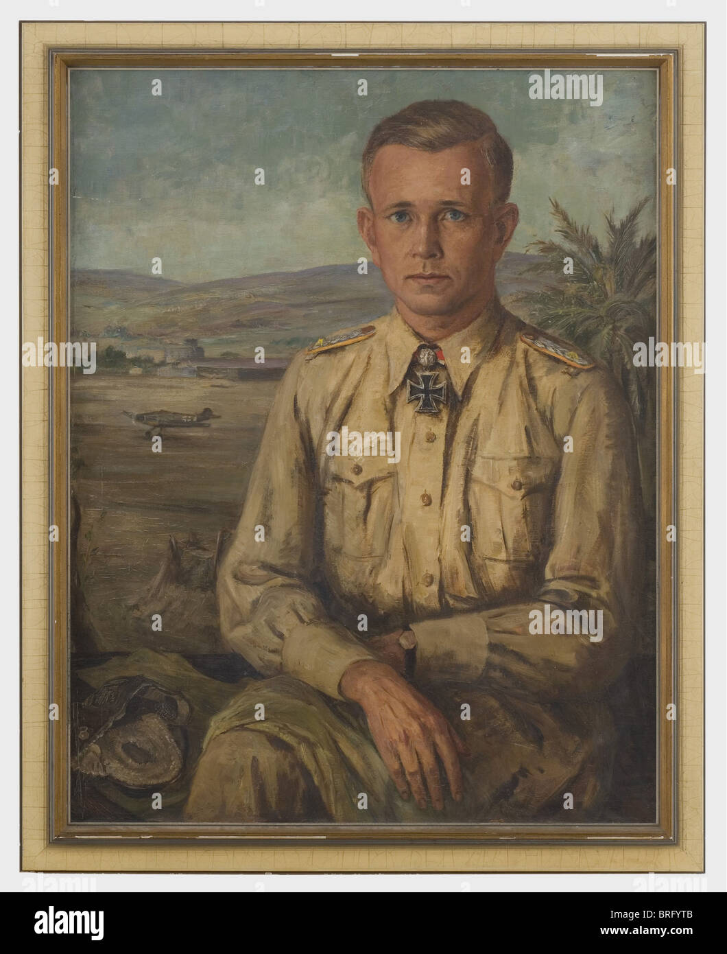 Oberst Günther Freiherr von Maltzahn (1910 - 1953), a portrait Oil on canvas. The fighter pilot and squadron commander as a Lieutenant Colonel wearing the Knight's Cross of the Iron Cross with Oakleaves, his headgear beside him, in front of a flying field in North Africa. Slightly crackled with a small touch-up in the upper right. In a modern frame, slightly damaged. Portrait dimensions 70 x 90 cm, framed dimensions 81 x 100. Colonel von Maltzahn, with 68 air victories, was commander of the famed Flying Squadron 53 'Pik As' (Ace of Spades) from 1940 to 1943. In, Stock Photo
