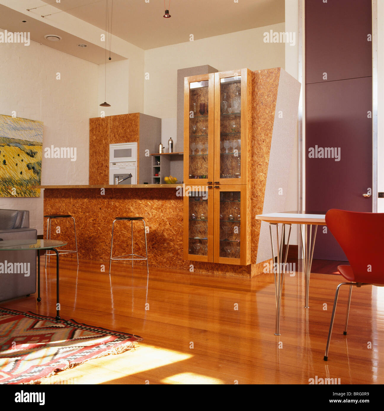 Lacquered woodchip surface on fitted units in modern kitchen with