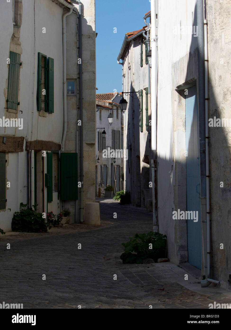 A quiet shady street in the French Town of St Martin de Re on the Ile de Re Stock Photo