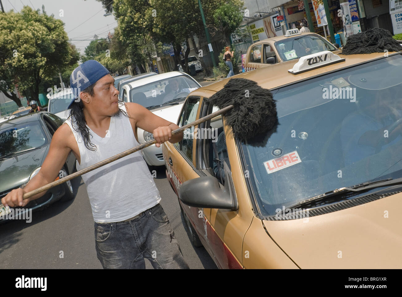 The street remains the last refuge of the unemployed, like these dust mop car  cleaners in Mexico City Stock Photo - Alamy