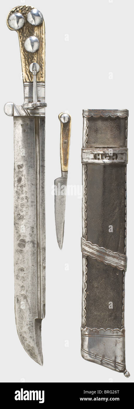 A heavy German 'Waidpraxe'(hunting cutlass),circa 1660.A massive blade with an asymmetrical cross-section,a double-edged semi-clip point,a narrow fuller on one side,and three small smith marks at the base of the blade.Decorative cut grip ferrule with a ring-shaped guard.Brass backed staghorn grip scales with four humped iron rivets on the obverse side.Leather covered wooden scabbard with iron mountings.A by-knife with staghorn grip scales sheathed in front.Below the by-knife is an openwork band with the monogram 'HGH' for Hans(Johannes)Georg Duke o,Additional-Rights-Clearences-Not Available Stock Photo