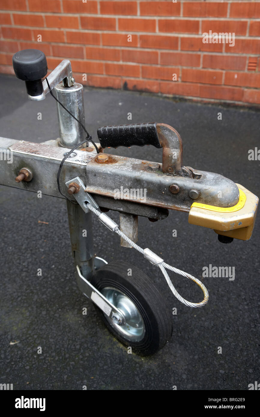 old trailer tow hitch lock with security safety cable and new jockey wheel Stock Photo